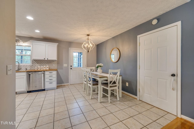dining room with baseboards, a notable chandelier, and a wealth of natural light