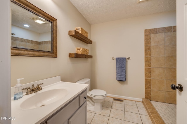 full bath featuring a textured ceiling, toilet, tile patterned floors, vanity, and tiled shower