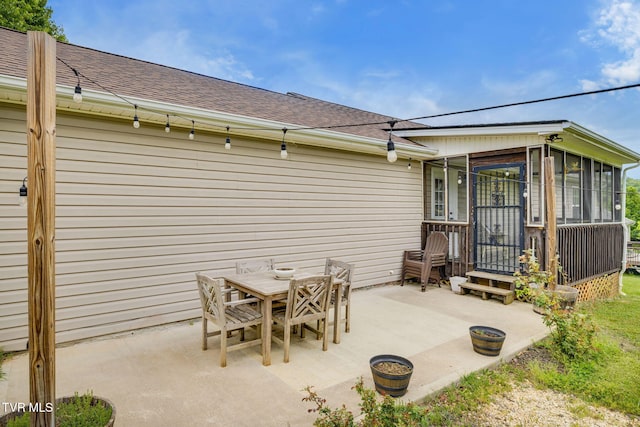 view of patio / terrace with outdoor dining area and a sunroom