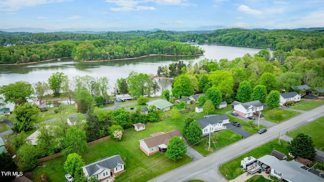 drone / aerial view with a water view and a wooded view