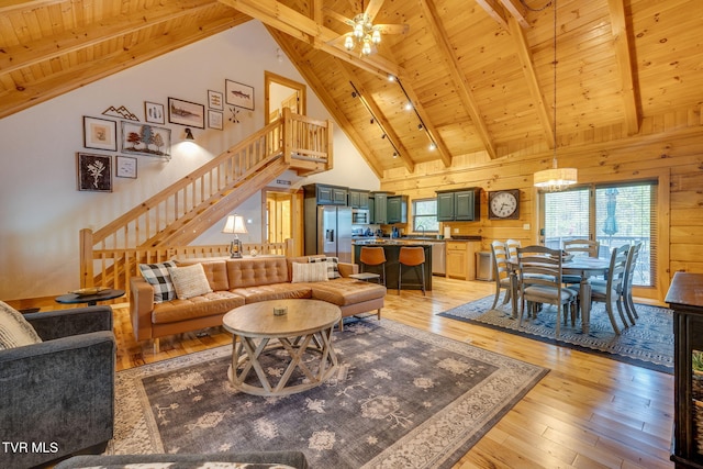 living area with stairs, wooden ceiling, beam ceiling, and light wood-type flooring