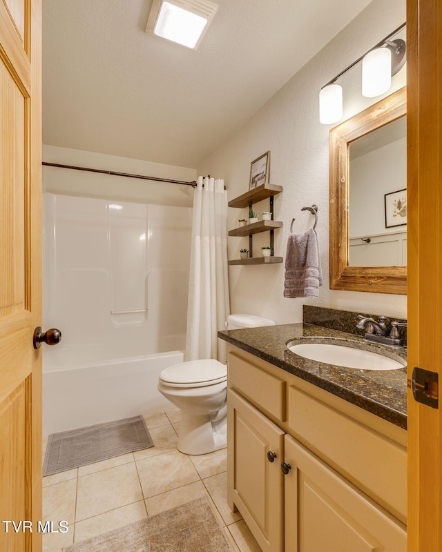 full bath featuring toilet, tile patterned floors, shower / bath combo, and vanity