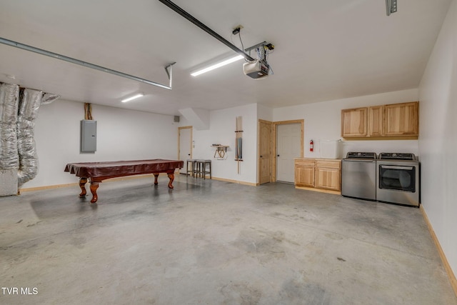 garage with baseboards, a garage door opener, electric panel, and washing machine and clothes dryer