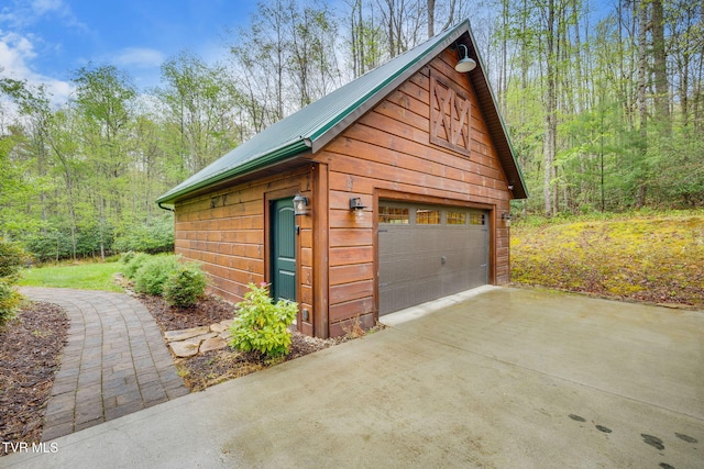 detached garage with a forest view