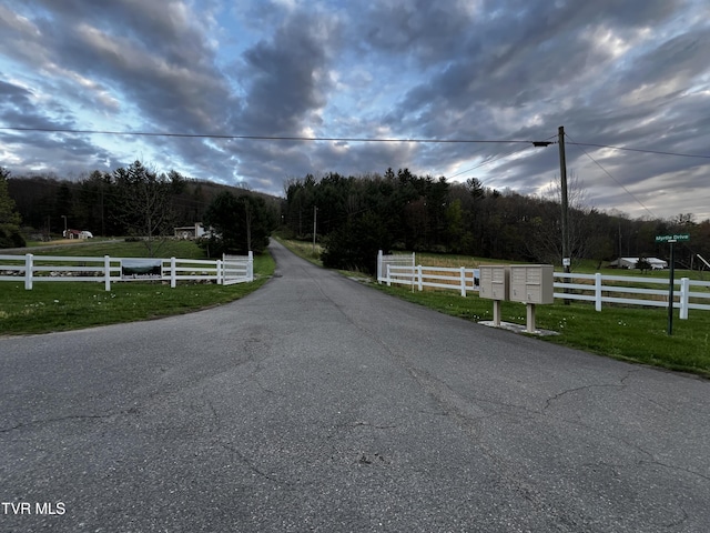 view of street featuring a view of trees and a rural view