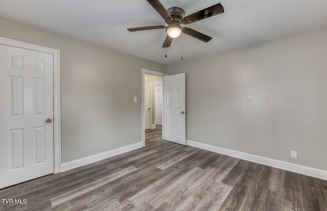 unfurnished bedroom with baseboards, wood finished floors, and a ceiling fan