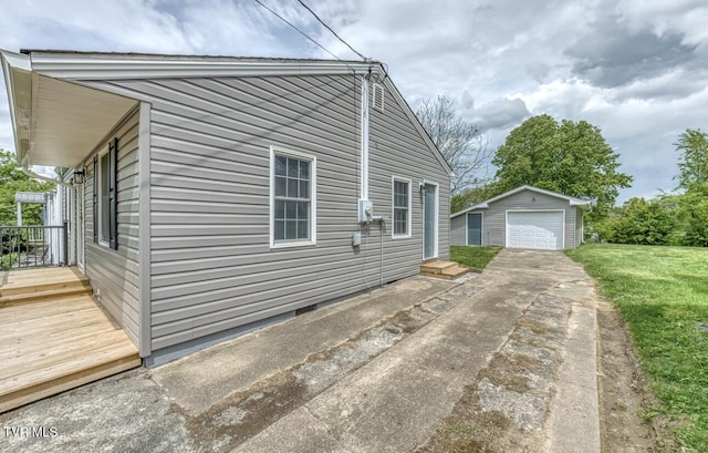 view of property exterior with an outdoor structure, concrete driveway, crawl space, and a garage