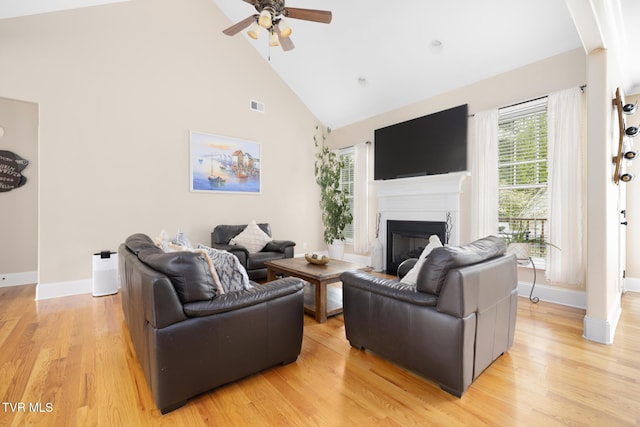 288 Max Jett Rd, Johnson City, TN 37601 - living area featuring a glass covered fireplace, light wood-style flooring, a ceiling fan, baseboards, and visible vents