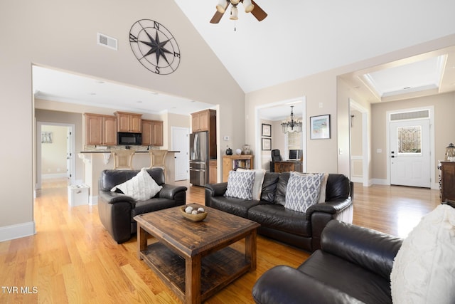 288 Max Jett Rd, Johnson City, TN 37601 - living area with visible vents, baseboards, high vaulted ceiling, light wood finished floors, and ceiling fan with notable chandelier