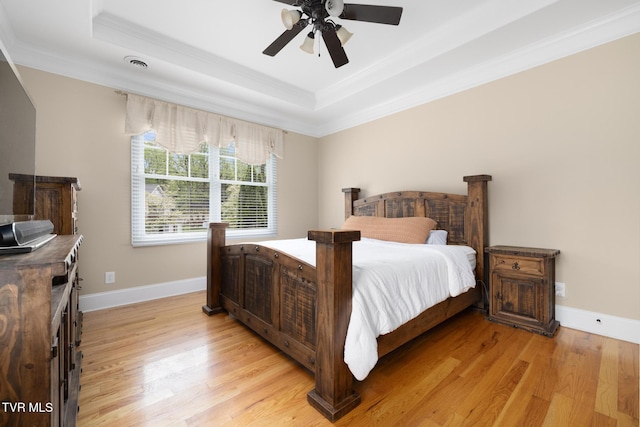 288 Max Jett Rd, Johnson City, TN 37601 - bedroom featuring crown molding, baseboards, a tray ceiling, and light wood-style flooring