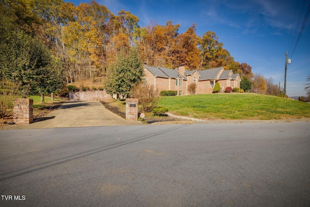view of front of property with a chimney and a front yard