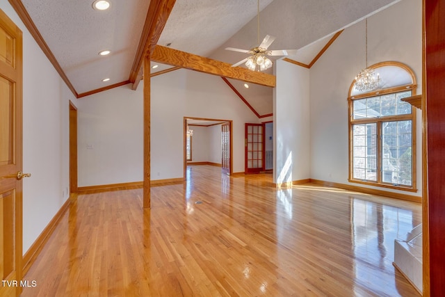 unfurnished living room with ornamental molding, light wood-style floors, and lofted ceiling