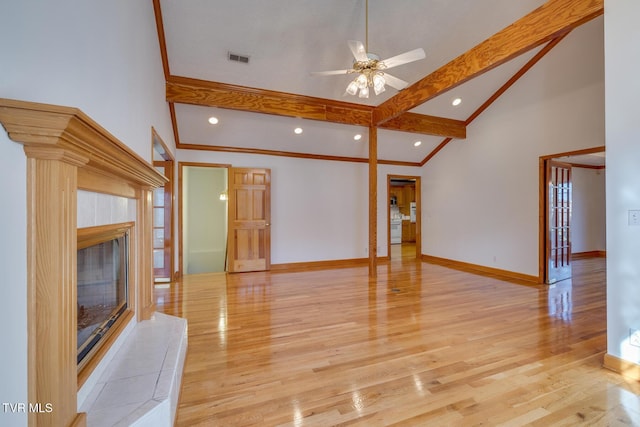unfurnished living room with light wood-style flooring, beamed ceiling, ceiling fan, baseboards, and visible vents