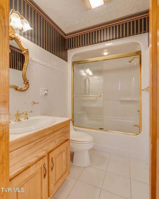 bathroom featuring tile patterned floors, enclosed tub / shower combo, ornamental molding, toilet, and vanity