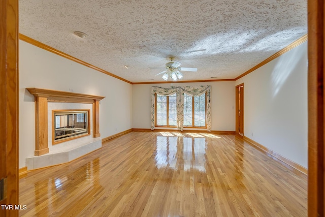 unfurnished living room with crown molding, ceiling fan, and light wood-style flooring