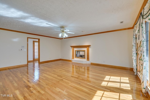 unfurnished living room featuring a textured ceiling, a ceiling fan, baseboards, and light wood-type flooring