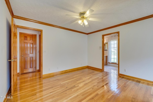 unfurnished room featuring a ceiling fan, baseboards, a textured ceiling, and light wood-type flooring