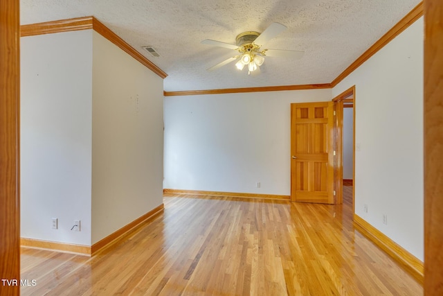 spare room with ornamental molding, a textured ceiling, ceiling fan, and light wood-style flooring
