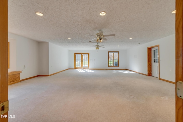 unfurnished room with recessed lighting, ceiling fan, carpet flooring, baseboards, and a textured ceiling