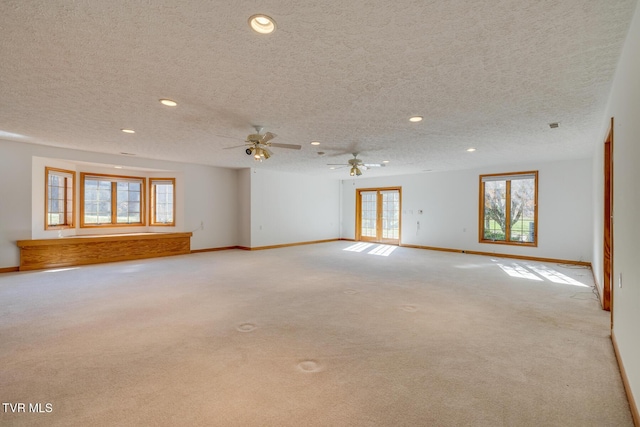 spare room with recessed lighting, ceiling fan, baseboards, a textured ceiling, and carpet floors