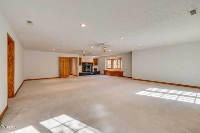 unfurnished living room featuring recessed lighting, baseboards, and light carpet