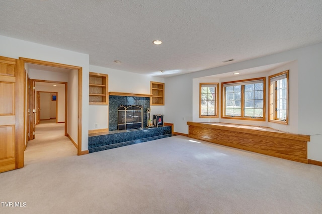 unfurnished living room with a fireplace, recessed lighting, carpet flooring, and baseboards