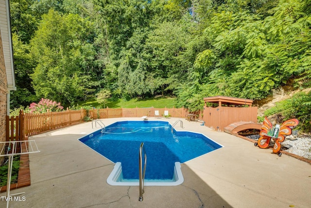 view of swimming pool featuring a patio, a fenced in pool, and a fenced backyard
