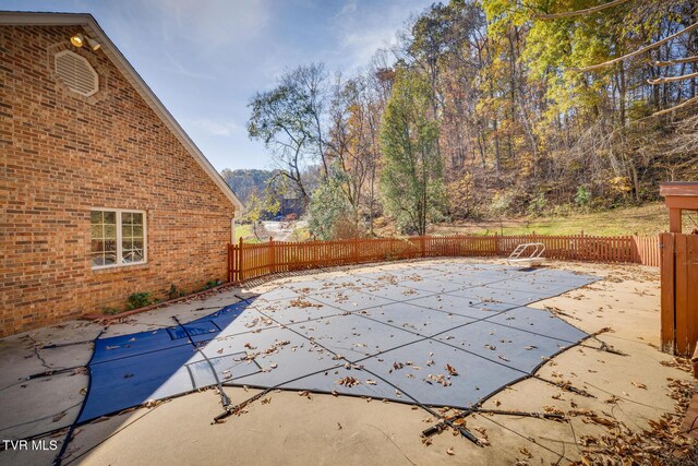 view of swimming pool with a patio, a fenced backyard, and a fenced in pool
