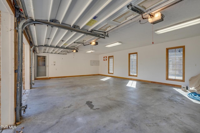 garage with baseboards and a garage door opener