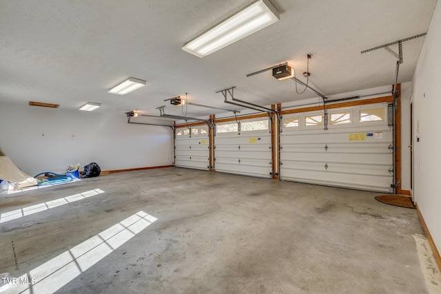 garage featuring baseboards and a garage door opener