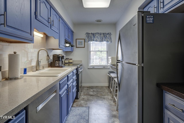 400 Sunset Dr Unit P83, Johnson City, TN 37604 - kitchen featuring a sink, under cabinet range hood, tasteful backsplash, blue cabinets, and appliances with stainless steel finishes