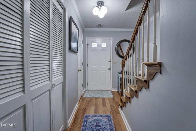 400 Sunset Dr Unit P83, Johnson City, TN 37604 - entryway featuring crown molding, a textured ceiling, stairs, baseboards, and wood finished floors