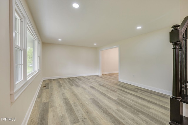 unfurnished living room with recessed lighting, light wood-style flooring, and baseboards
