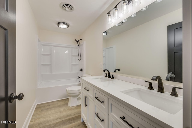 full bath with wood finished floors, visible vents, toilet, and a sink