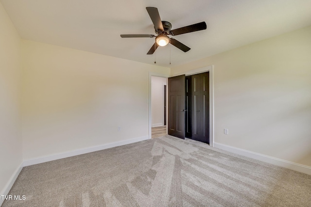 unfurnished bedroom with baseboards and light colored carpet