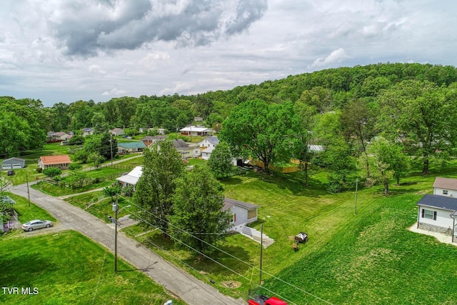 drone / aerial view with a wooded view