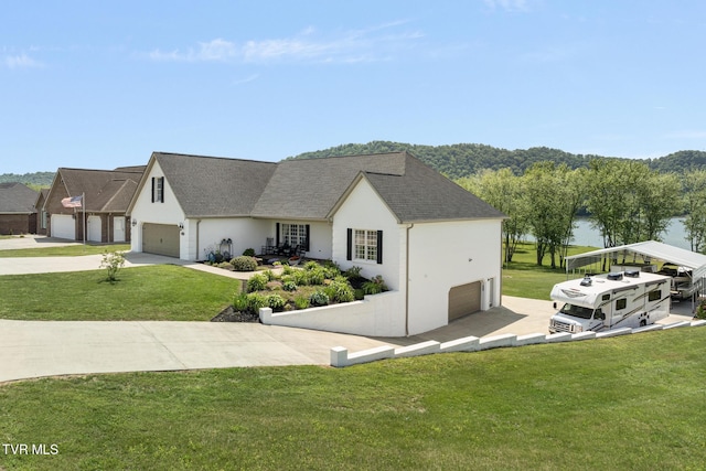 exterior space with driveway, a lawn, an attached garage, a shingled roof, and stucco siding