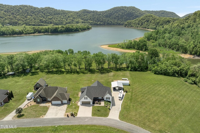 aerial view with a water view and a forest view
