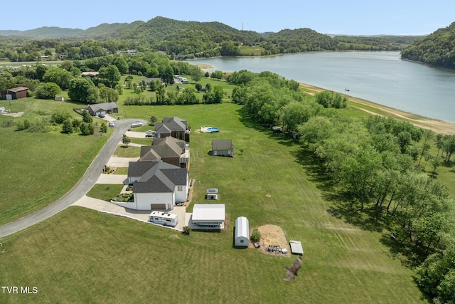 drone / aerial view with a water view and a wooded view