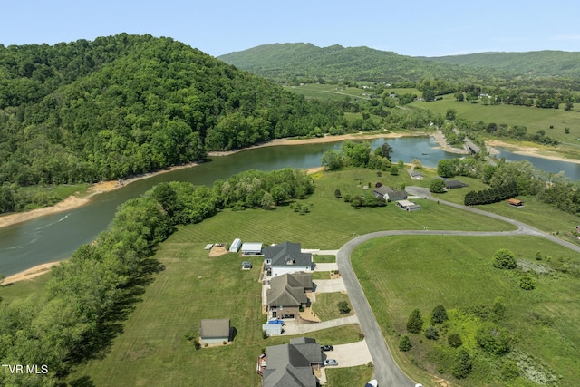 bird's eye view with a water and mountain view and a view of trees
