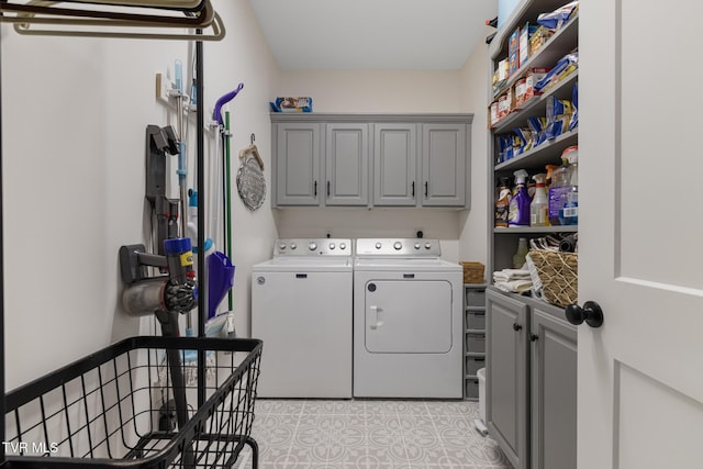 washroom with cabinet space and washer and dryer