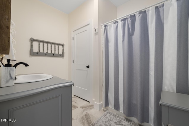 bathroom featuring vanity, marble finish floor, and a shower with shower curtain