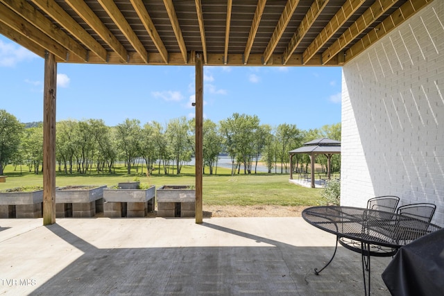 view of patio featuring a gazebo and a water view