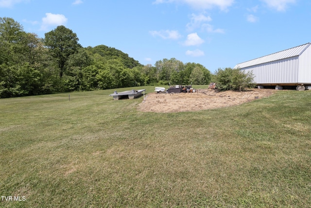 view of yard with a view of trees