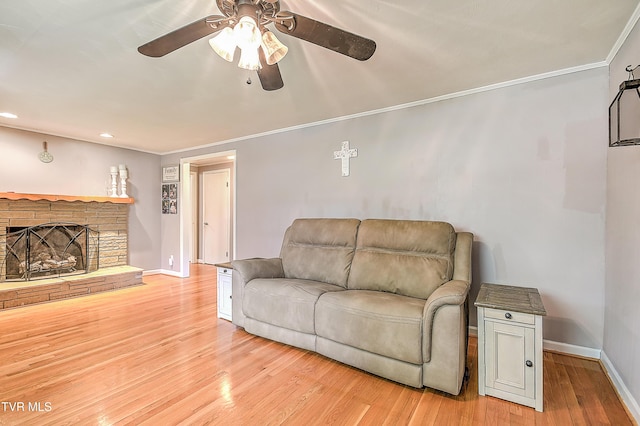 19032 Woodland Hills Rd, Abingdon, VA 24210 - living area featuring light wood-style floors, a brick fireplace, crown molding, a ceiling fan, and baseboards