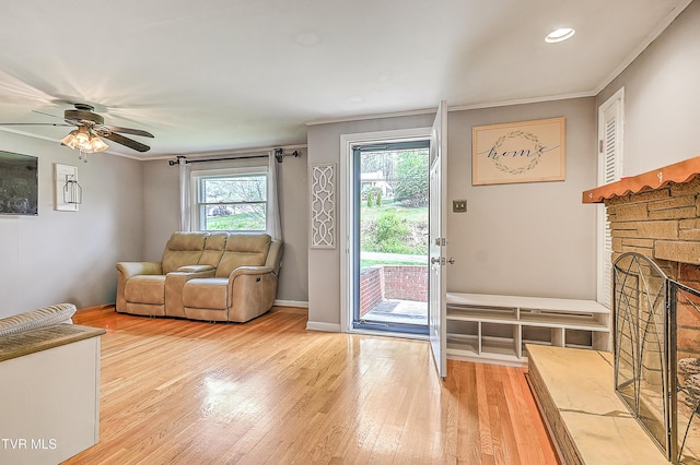 19032 Woodland Hills Rd, Abingdon, VA 24210 - living area featuring wood finished floors, a ceiling fan, crown molding, and a stone fireplace