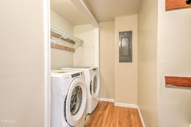 19032 Woodland Hills Rd, Abingdon, VA 24210 - laundry area featuring laundry area, light wood-style flooring, washing machine and clothes dryer, electric panel, and baseboards