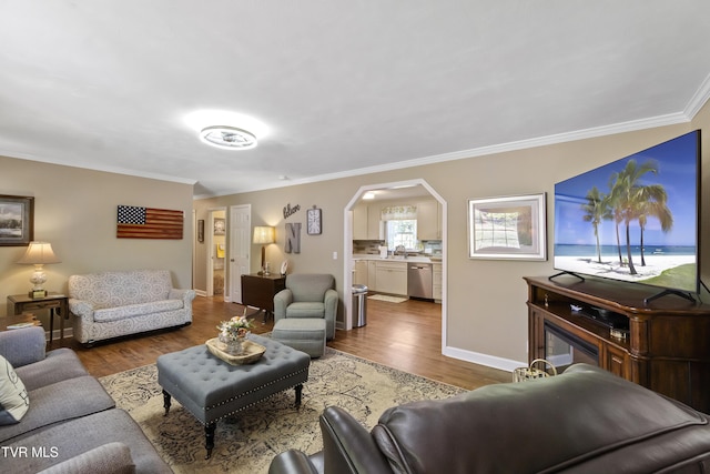 2004 Old Tusculum Rd, Greeneville, TN 37745 - living room featuring crown molding, arched walkways, baseboards, and wood finished floors