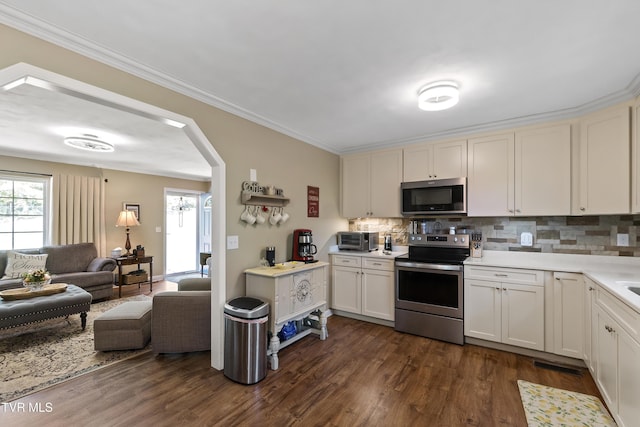 2004 Old Tusculum Rd, Greeneville, TN 37745 - kitchen with tasteful backsplash, arched walkways, stainless steel appliances, open floor plan, and dark wood-type flooring
