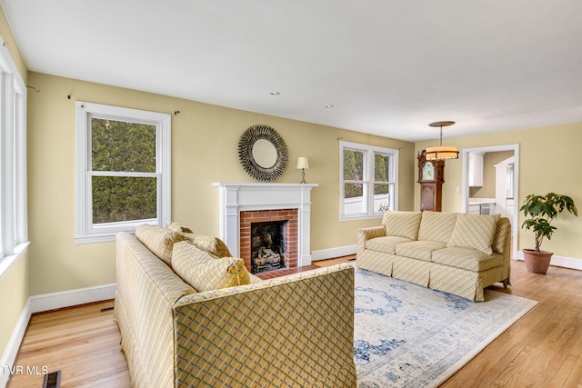 300 SW Grove Terrace Dr, Abingdon, VA 24210 - living room featuring baseboards, a fireplace, and light wood-type flooring